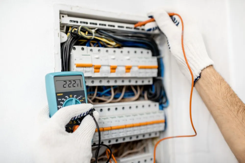 Sample after photo: a neat breaker panel with labelled breakers, a gloved hand holding a probe to a meter.